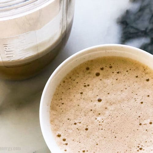 Creamy Bulletproof Coffee in a mug and the blender cup with extra coffee