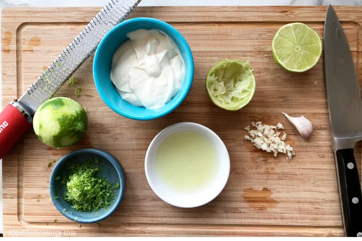 Lime zest, mayonaise, lime juice, chopped garlic on a board for making aioli
