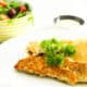 Keto Herb Crumbed Fish on a plate with Garlic Lime Aioli and a salad