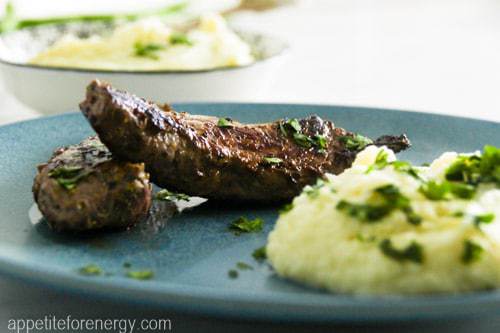 30 Minute Low Carb Mediterranean Herbed Lamb & Cauliflower Mash on a plate with fresh herbs