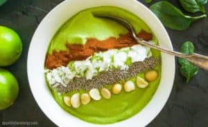 Green Keto Smoothie Bowl topped with macadamia nuts and chia seeds