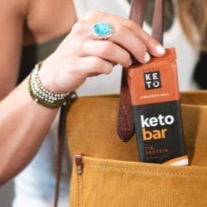 Lady getting a Keto Bar out of handbag