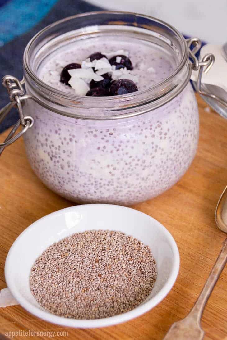 Blueberry Chia Pudding in a mason jar topped with blueberries and coconut flakes