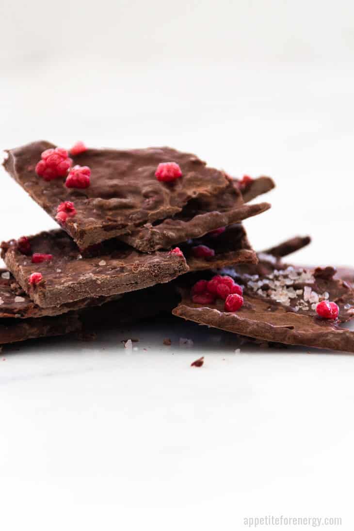 A stack of Salted Raspberry Chocolate Bark on a white bench