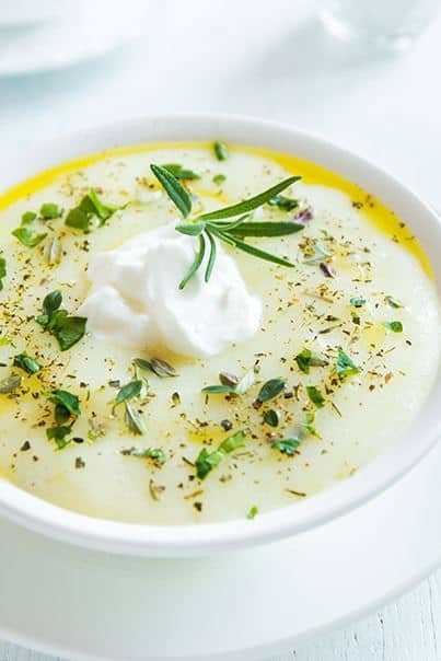 30 Minute Low-Carb Cauliflower Cheese Soup in a bowl with sour cream and herbs