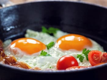 Bacon, eggs and tomatoes in a fry-pan