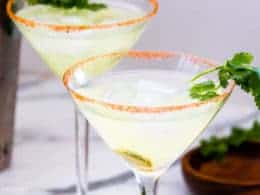 Low-Carb Spicy Margarita in a martini glass with cilantro garnish