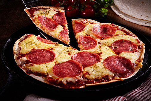 Low-carb tortilla pizza with salami