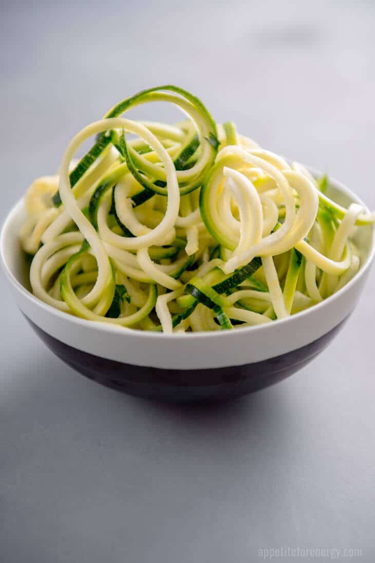 A black and white bowl full of freshly spiralized of Zucchini Noodles (zoodles)