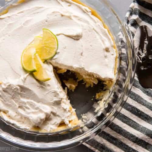 Key Lime Pie Icebox cake in glass dish with a slice removed from pie