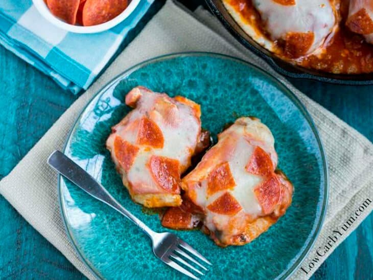 Low carb pizza chicken on a blue plate with a fork
