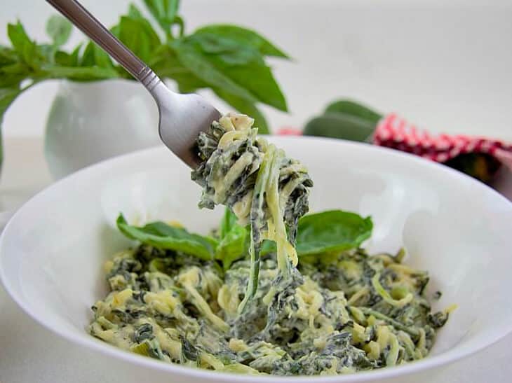 Low carb zucchini noodles being twirled around a fork from a bowl