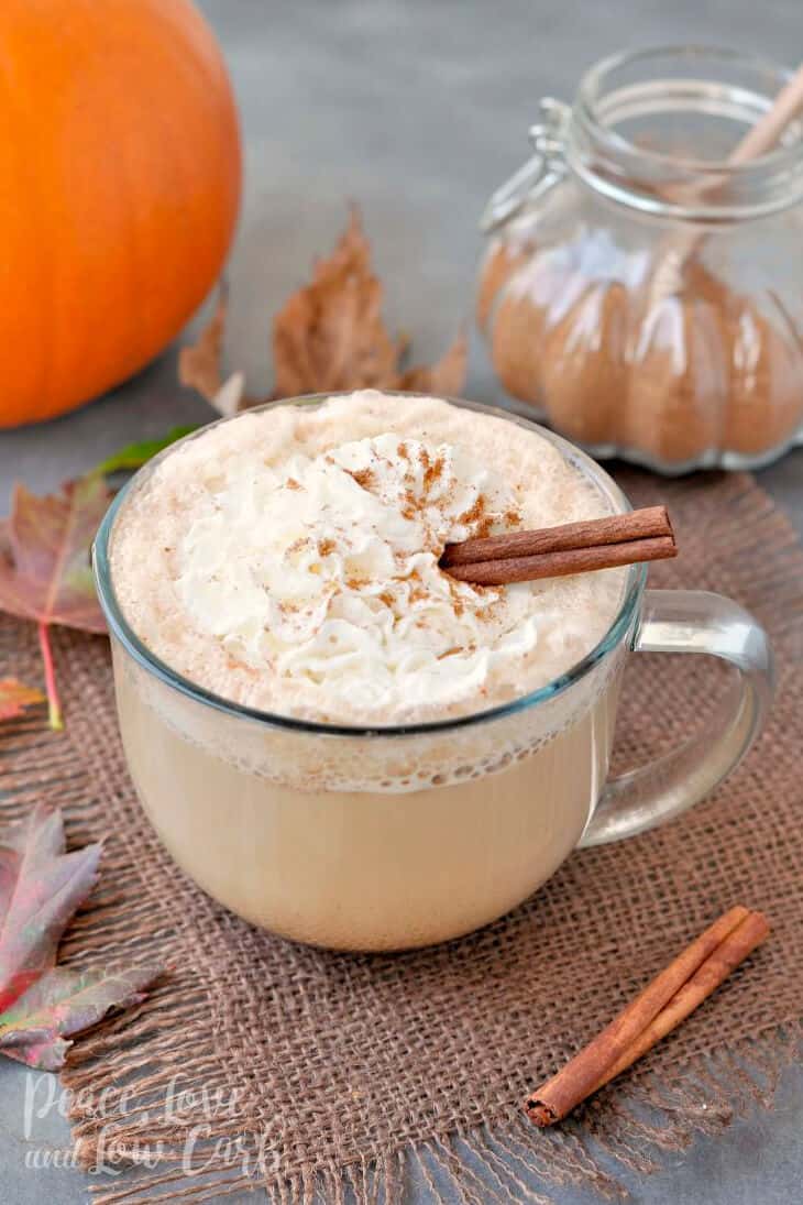 Keto Pumpkin Spice Latte topped with whipped cream, a dusting of pumpkin spice and a stick of cinnamon