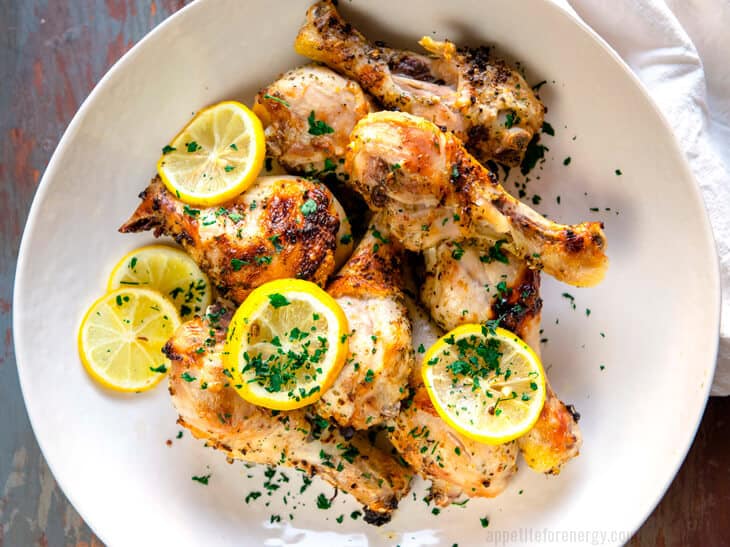 Herb Roasted Chicken Drumsticks with lemon served in a big white bowl