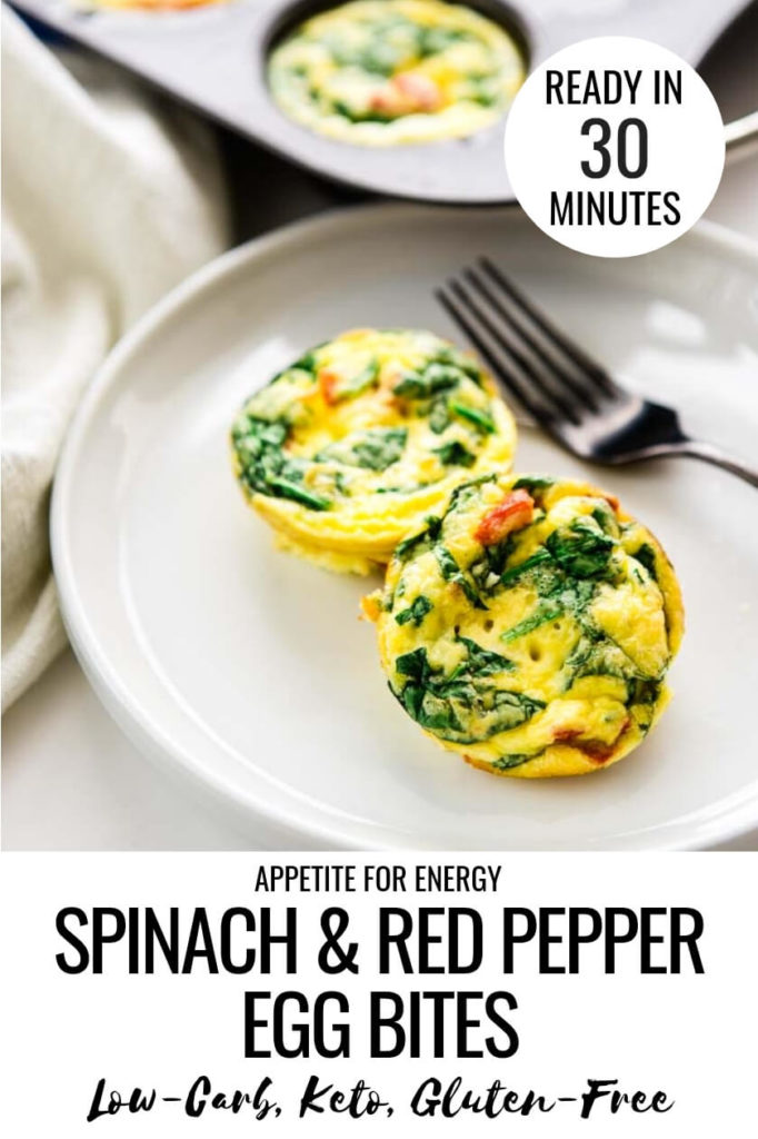 2 Spinach and Red Pepper Egg Bites on a plate with a fork and more egg bites in the muffin tin