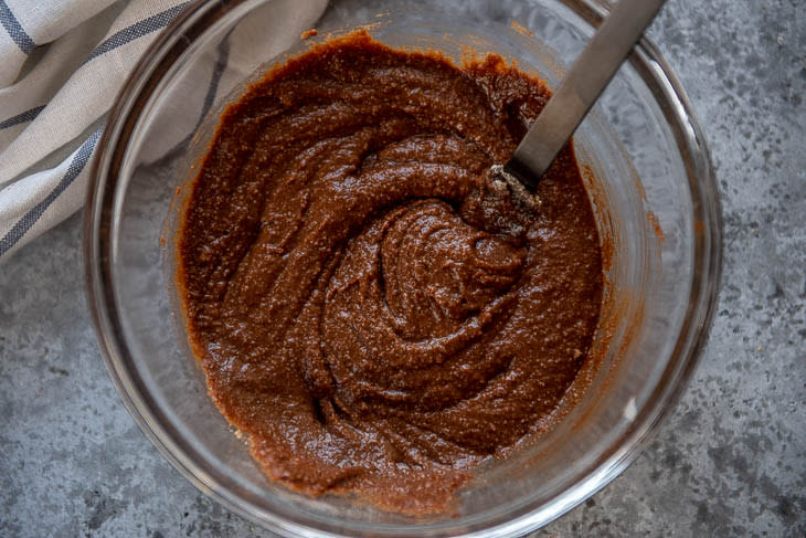 Bowl with almond flour mixed in with cocoa and other ingredients 
