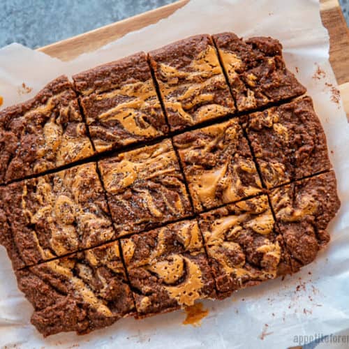 Keto Peanut Butter Brownie slab cut into pieces on baking paper