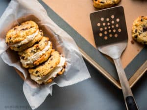 Keto Chocolate Chip Cookie Sandwiches arranged in a tray with parchment paper and a spatula