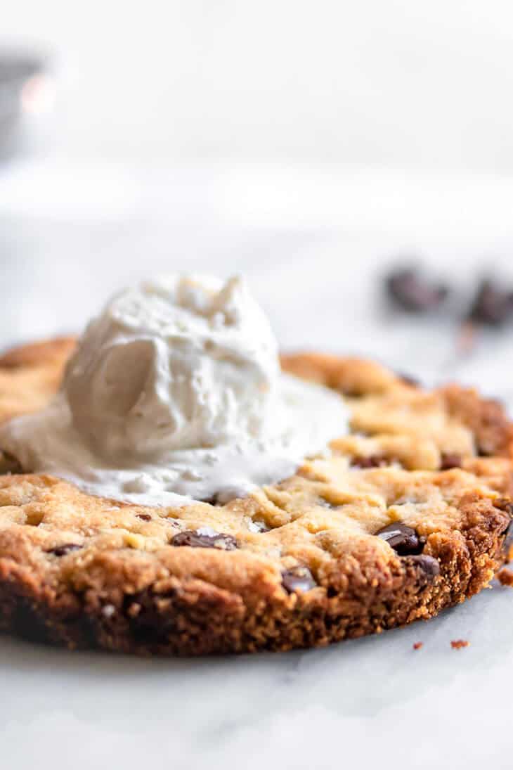 Chocolate chip cookie for 2 with a dollop of whipped cream on top