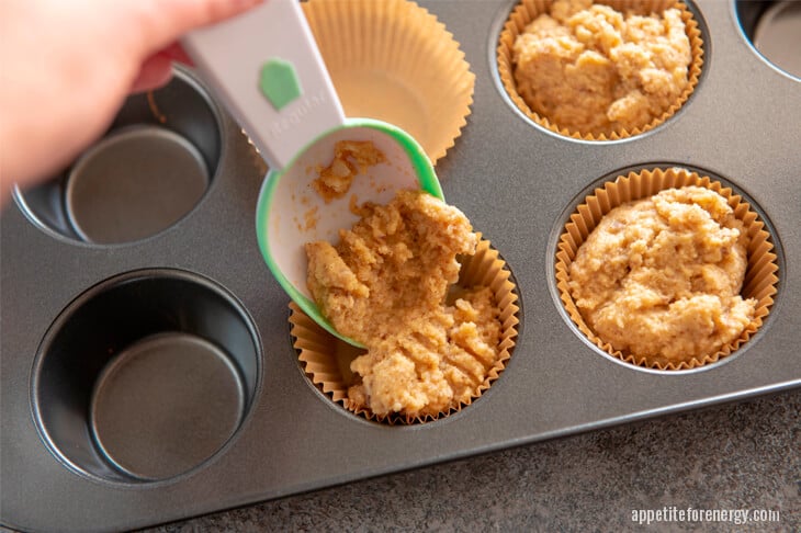 Step 3 Dividing cinnamon roll batter into muffin tins with a spoon