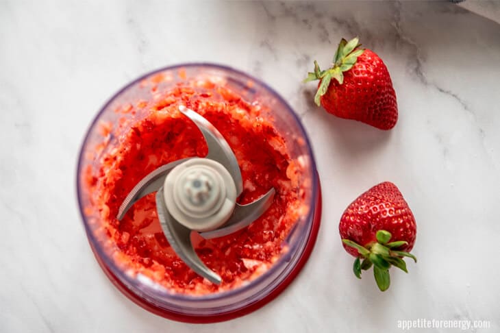 Blended strawberries in food processor for keto frosting