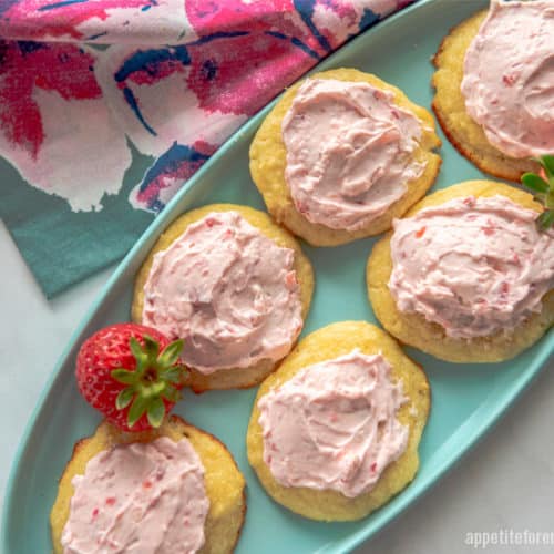 Keto Lemon Sugar Cookie with Strawberry Frosting on a green plate with floral cloth
