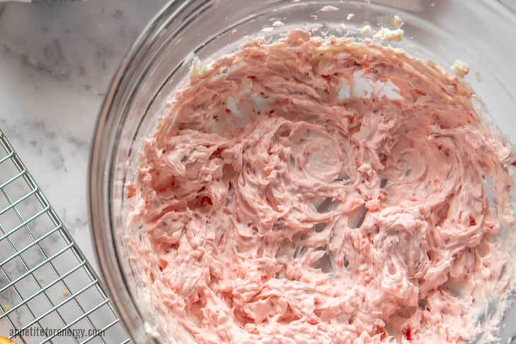 Keto Strawberry Frosting in a glass bowl with cooling rack