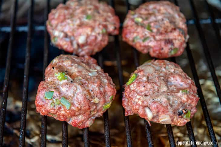 Cooking pork burgers on grill or barbecue