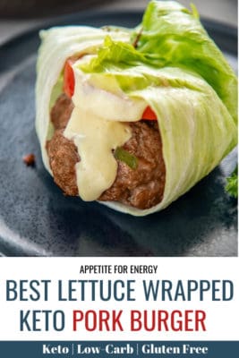 Lettuce wrapped pork burger with sauce drizzled over on blue plate