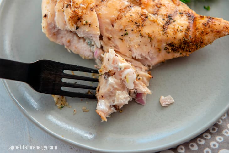 A fork picking up KETO Grilled Mushroom Stuffed Chicken Breast